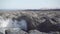 Close slomo shot of turbulent ocean waves crashing onto a rocky sea shore