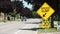 Close on speed hump arrow 20 km/h sign in black writing on yellow background