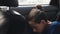 Close. Teenage boy sleeping in the back seat of car