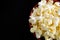 Close Top View of Buttered Popcorn in a Red Bowl Isolated on Black