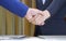 Close up 2 business people shaking hands after meeting finished in office room
