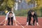 Close up of 20 year old businessmen and businesswoman ready to run at start point.