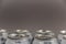 Close-up of 330 ml tin cans. Metallic silver individual beverage containers. Front focus. Noise, blur, grain effect