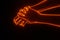 Close up 3D view of hand grabbing hand with light fire glowing effect. Stopping to do something concept