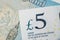 Close-up of 5 pound sterling England currency banknotes, Brexit, UK economics, saving, financial or investment with