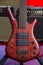 Close up of a 5-string matte red solid electric bass