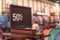 Close-up 50 percent off sale sign over clothes at department store in Texas, America