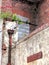 Close up of an abandoned derelict old house with crumbling brick walls and blocked up window and rusty drainpipe