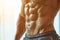 close up of abdominal muscles on the sporty male stomach over white