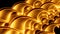 Close up of abstract plastic golden springs stretching isolated on a black background. Design. Spiral shaped long wavy