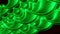 Close up of abstract plastic green springs stretching isolated on a black background. Design. Spiral shaped long wavy