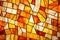 close-up of an abstract stained glass design in warm tones