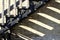 Close up abstract view of a vintage city fire escape stairs casting unique shadows in late day sun