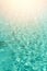 Close up abstract water texture. Turquoise swimming pool water background. Copy space, top view. Sun light effect and