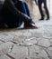 Close up of addicts and drug syringes on ground