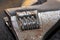 A close up of the adjustment wheel on a rusty adjustable wrench using selective focus