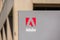Close up. Adobe logo on signpost at Adobe Inc headquarters