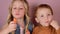 Close-up of adorable cute caucasian children brother and sister twist a finger