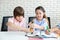 Close up, adorable kid boy and girl in international school are studying drawing class while sitting with happy face