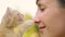 CLOSE UP: Adorable orange tabby kitten meows and touches the young woman\'s nose.
