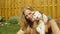 CLOSE UP: Adorable shot of a blonde girl cuddling with a soft white puppy.