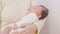Close up Adorable sleeping newborn baby relax in mother arm safety and comfortable.Smile Asian newborn infant baby resting