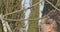 Close-up of adult Caucasian man cutting branches on tree outdoors. Side view of senior guy taking care of garden on