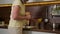 Close up adult woman pouring orange juice from bottle to glass in kitchen middle-aged female housewife granny drink