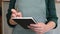 Close-up adult woman waiter with notepad in restaurant takes order