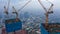 Close up aerial view of crane lowering an object on the roof of the skyscraper under construction in Jakarta, Indonesia