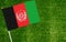 Close-up of Afghanistan flag against closed up view of grass
