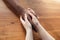 Close up of african-american male and caucasian female hands holding