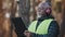Close-up african american male professional foreman forestry engineer standing outdoors wearing protective headphones