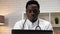Close up African American man doctor working uses computer in clinic office