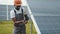 Close up of african american man in grey overalls measuring resistance in solar panels outdoors. Competent technician