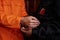 Close-up of African American policeman in uniform putting on or off cuffs