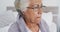 Close up of african american senior woman drinking coffee while sitting on the bed at home