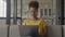 Close up of an African American woman smile and laugh while working on her laptop computer