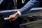 Close-up of african man`s hand opening the door of car