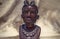 Close up of African traditional wooden Statue figurine on a fur background