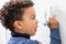 Close up of afro american boy drawing with marker pen on white board