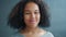 Close-up of Afro-American woman serious then smiling at camera feeling good