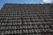 Close up of aged roofing tiles on old house in village. A lot of moss on tiled roof of hovel. Countryside scene