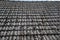 Close up of aged roofing tiles on old house in village. A lot of moss on tiled roof of hovel. Countryside scene