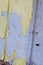 Close Up of Aged Yellow Paint Peeling on Industrial Wall in St. Louis