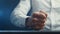 Close-up of an aggressive businessman beating his fist on the table. Stress at work.