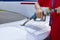 Close up of an aircraft worker fueling low-wing propeller driven airplane