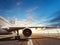 Close-up of airplane on runway in sunset light