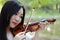 Close-up Aisan Chinese girl woman artist play violin in nature park forest enjoy leisure time performance outdoor lake sunset