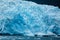 Close-up of Alaskan blue glacier edge and ice dotted ocean